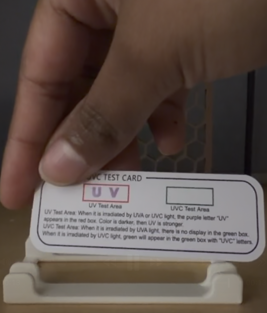 Two test strips compared — TiO2 coated vs uncoated, darker reading confirms absorption